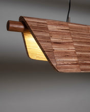 Load image into Gallery viewer, Wooden pendant light with a warm glow on a gray background
